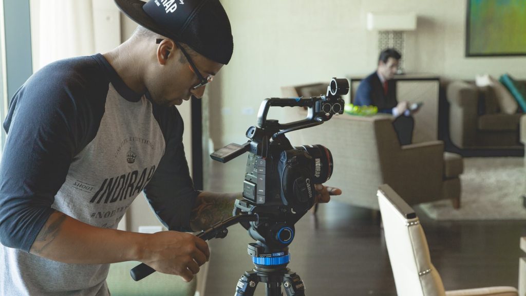 A man filming a video.